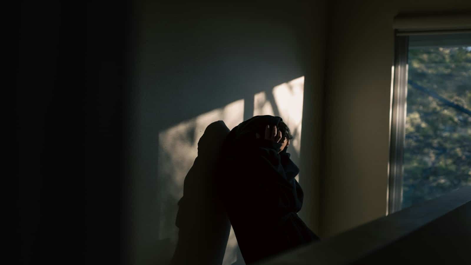 man sitting quietly in dim room