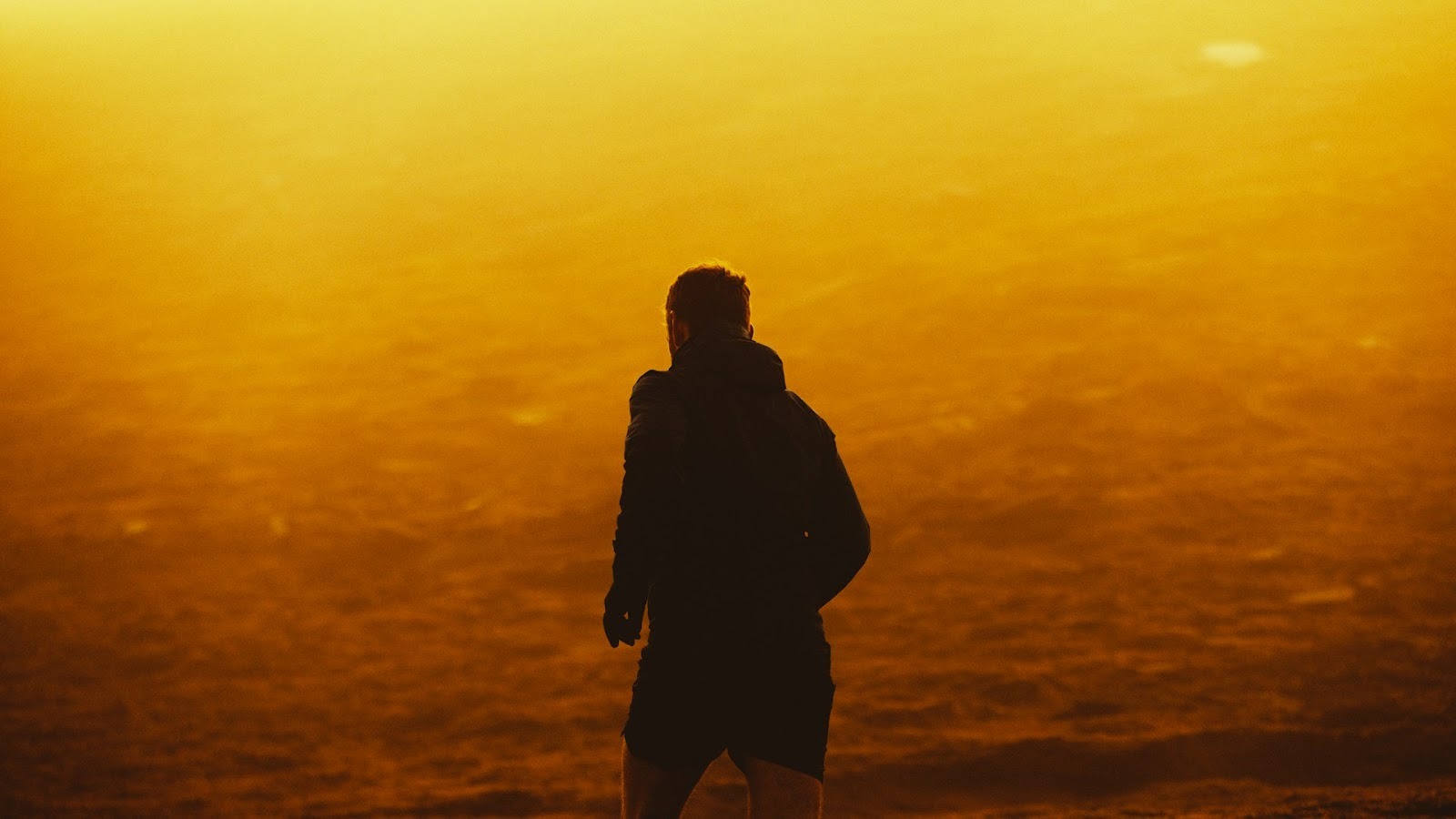 man walking confidently at sunrise