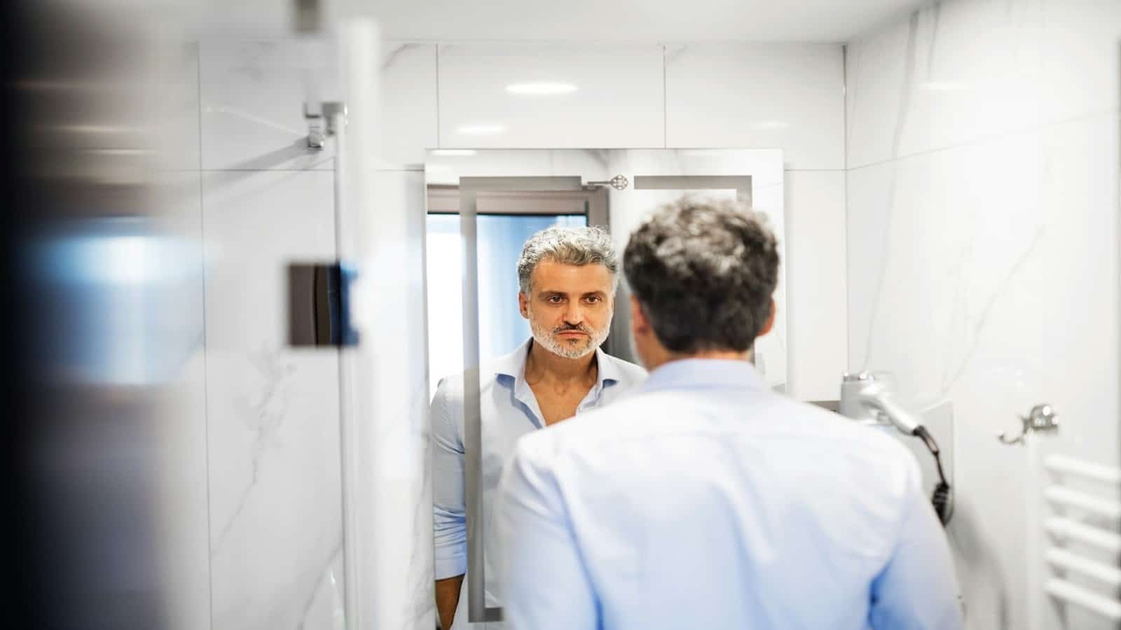 man looking serious in mirror