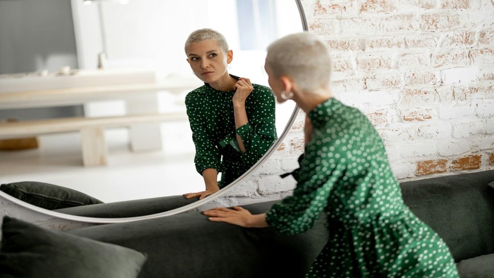 adult looking reflective in mirror
