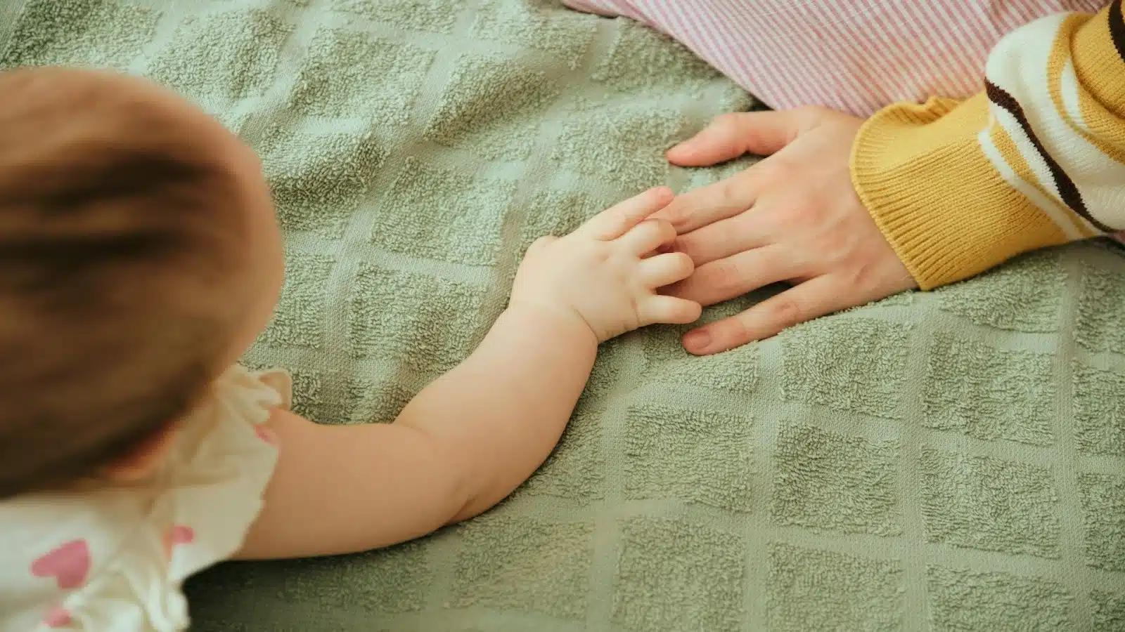child holding parent’s hand
