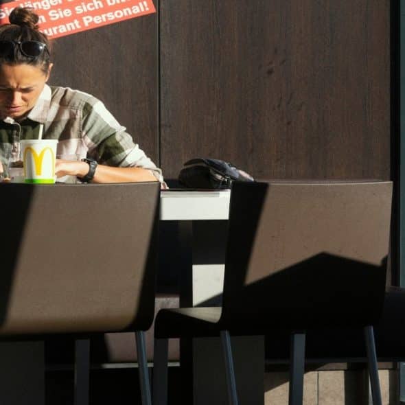 man sitting alone reviewing bills