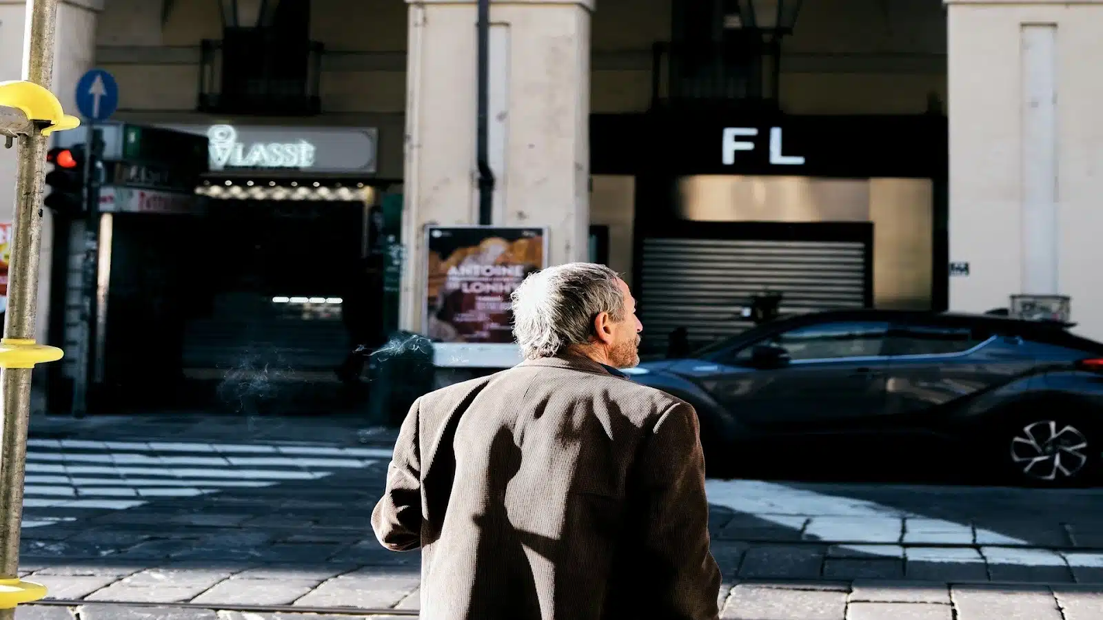 man standing thoughtfully in city