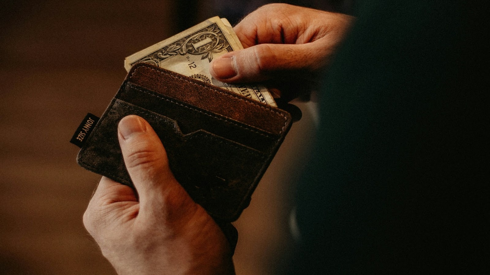 man checking wallet at restaurant