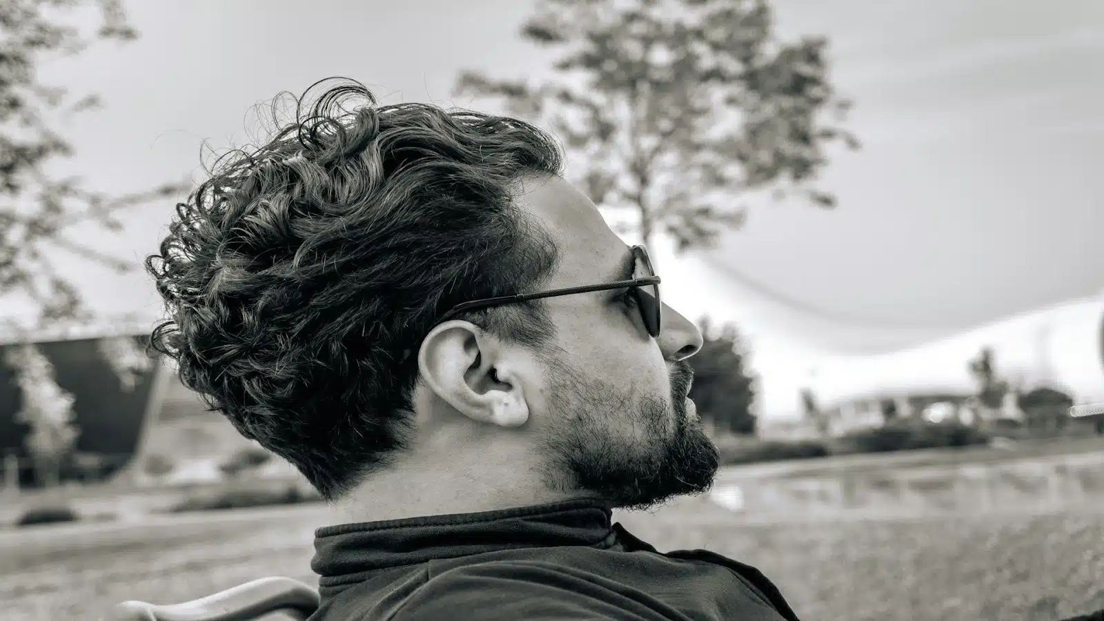 man looking thoughtful outdoors