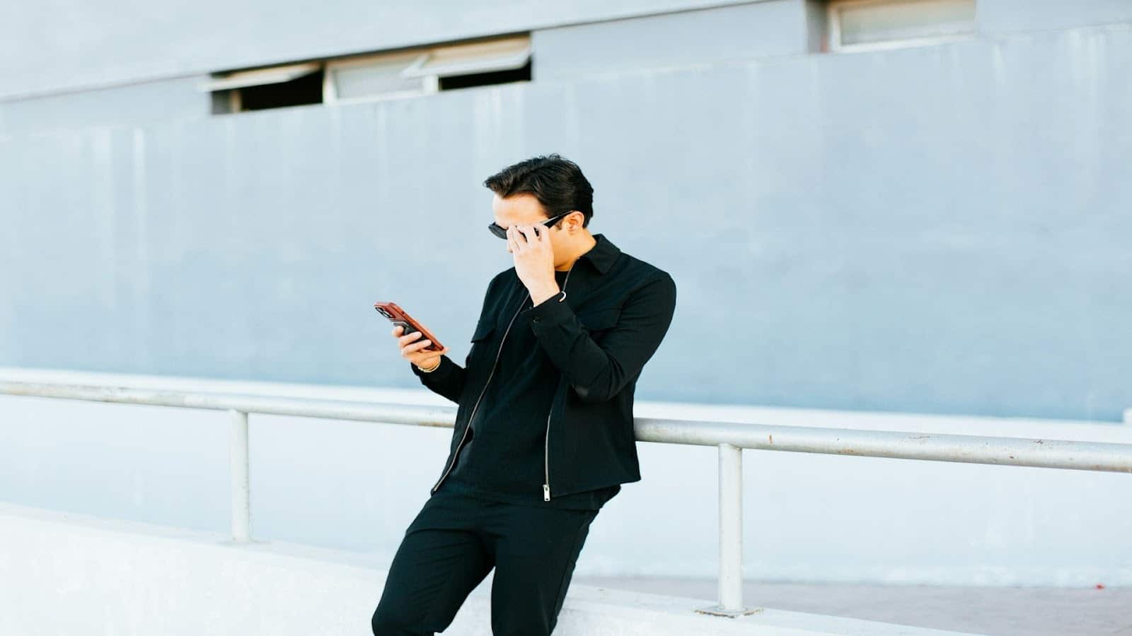 man scrolling phone alone