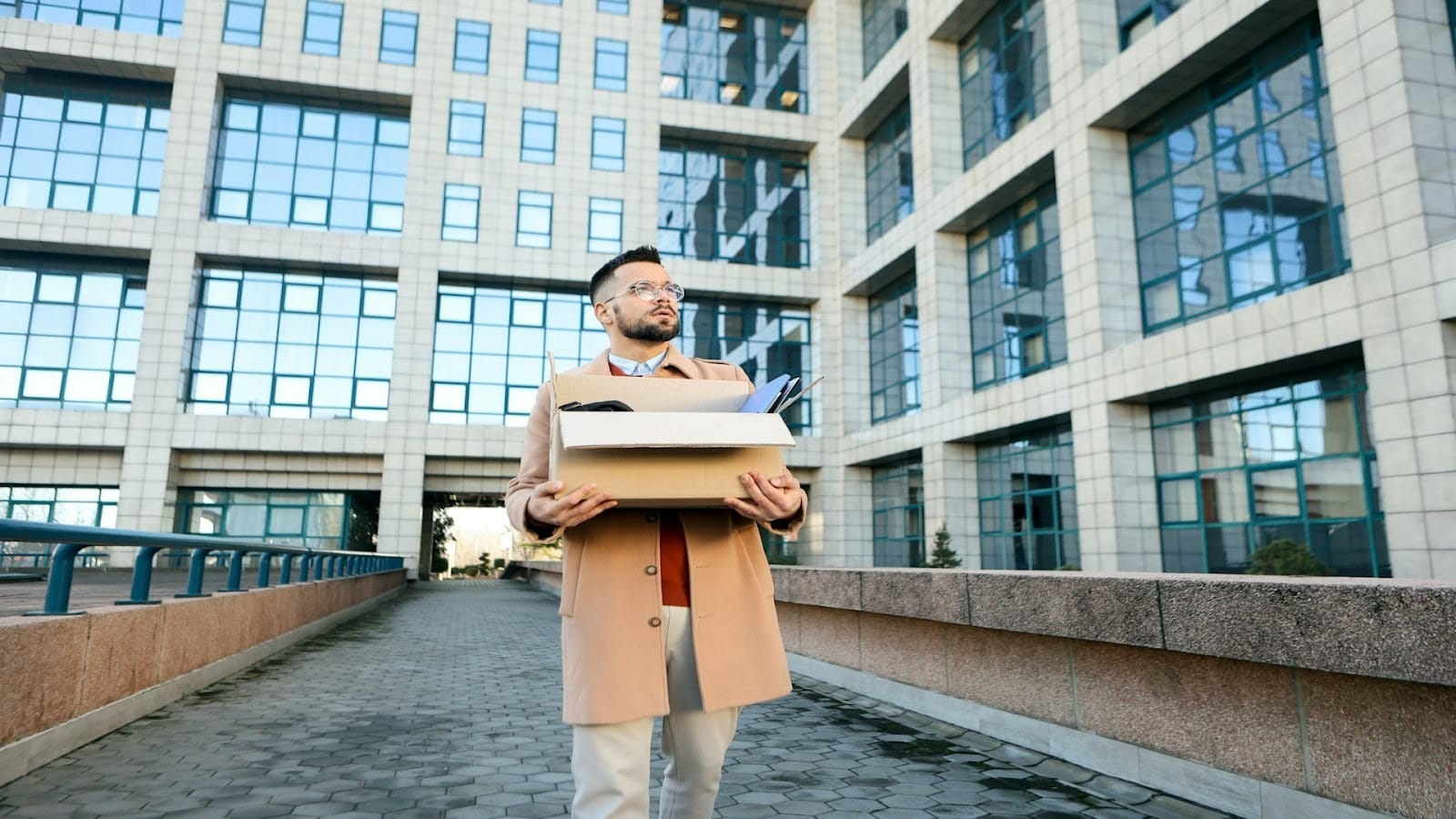man standing near office building