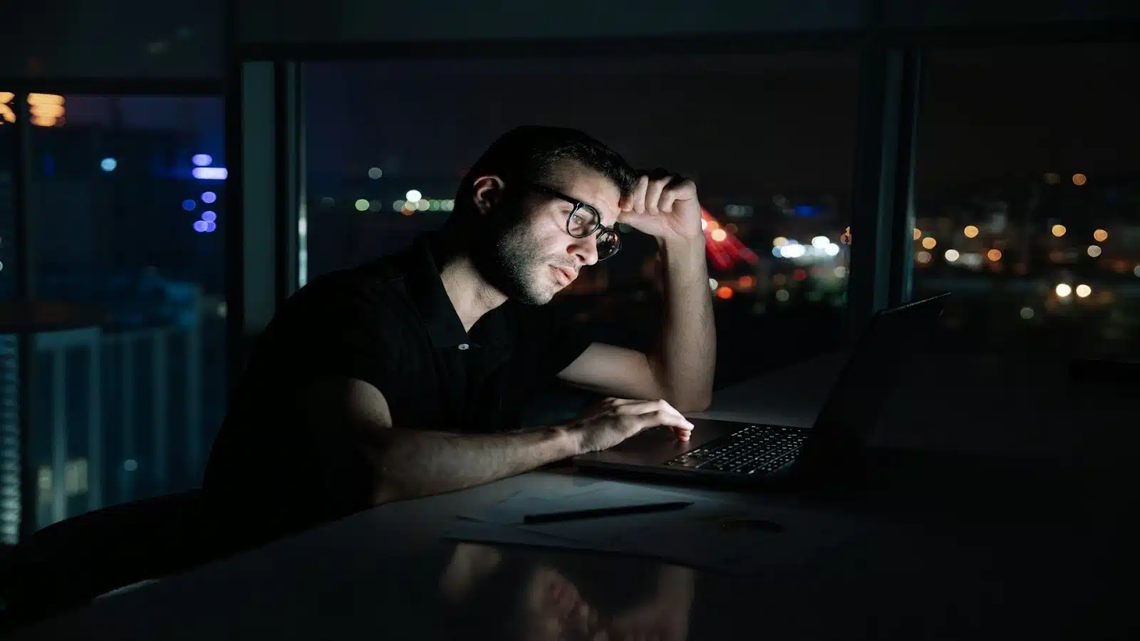 man working late at desk