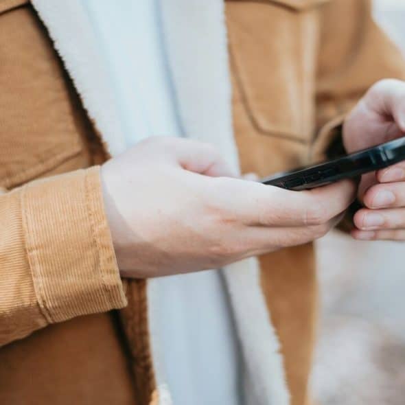 A man texting outdoors