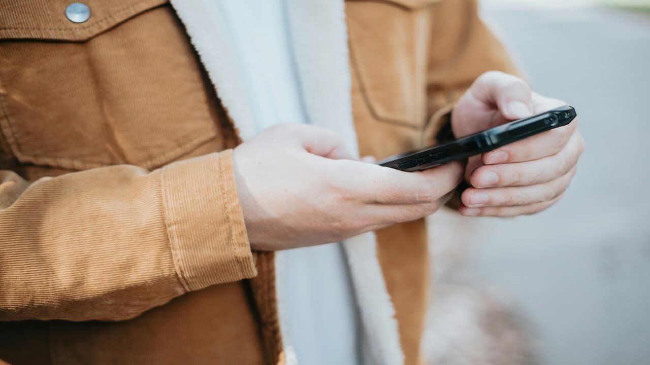 A man texting outdoors