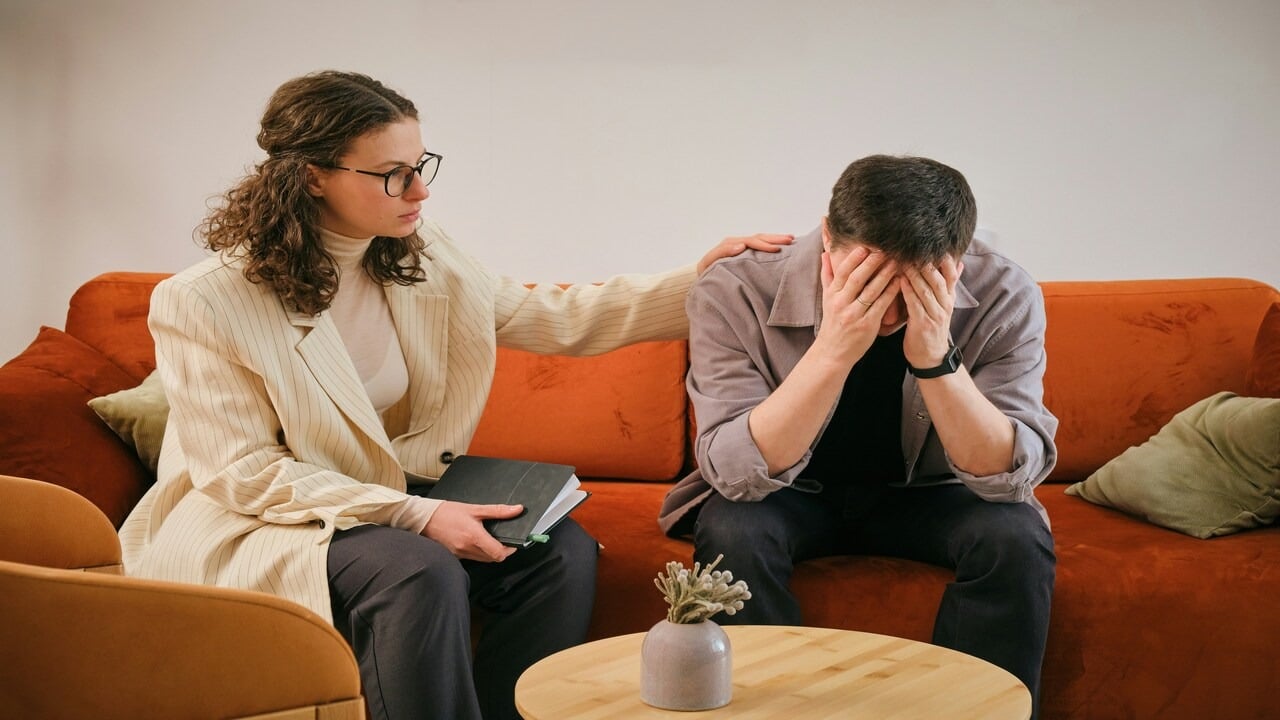 A frustrated man with a counselor