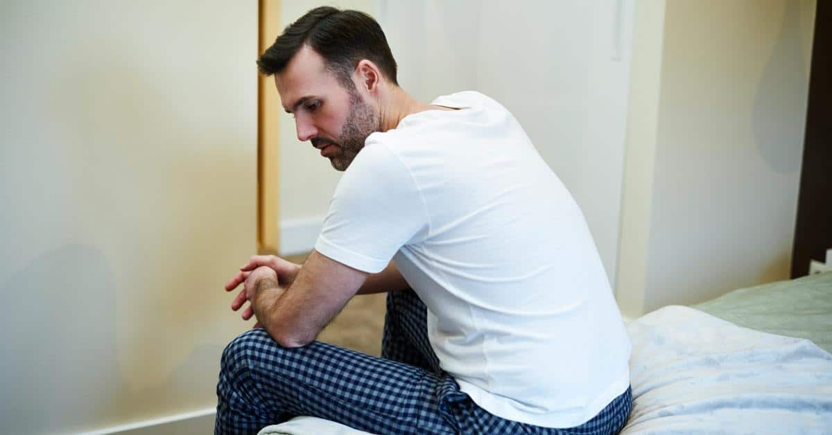 A man sitting on a bed