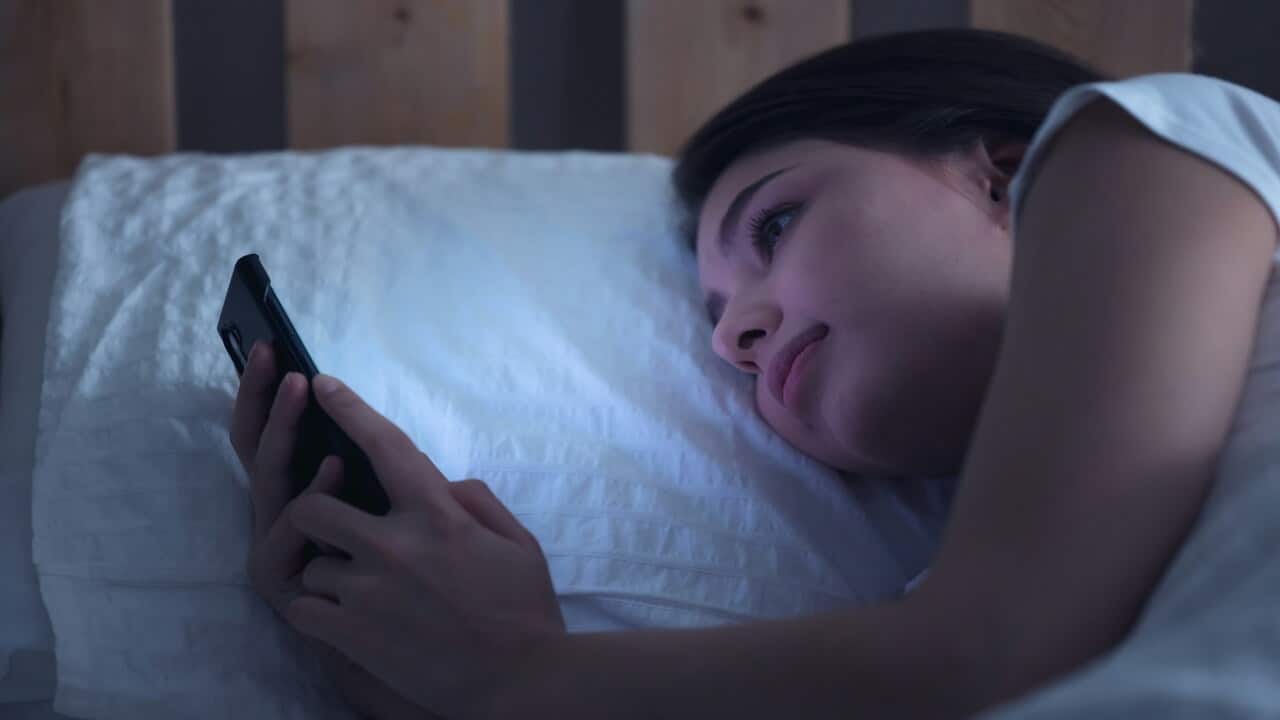 A woman looking sad while texting