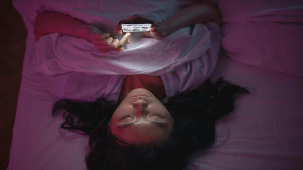 A woman texting in bed
