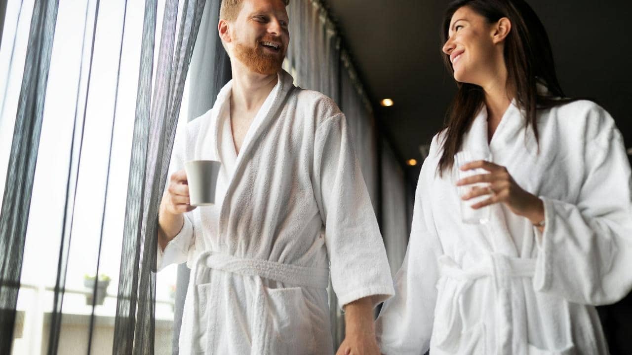 A couple in white bathrobes