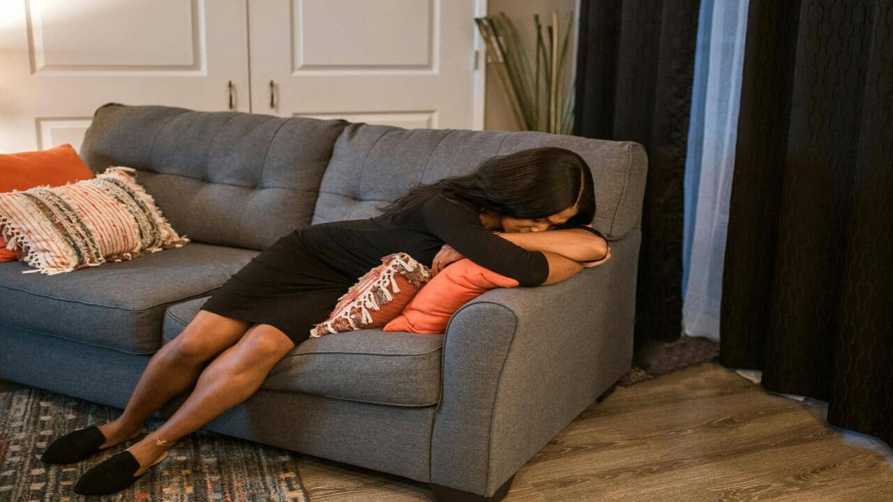 A woman looking sad at home