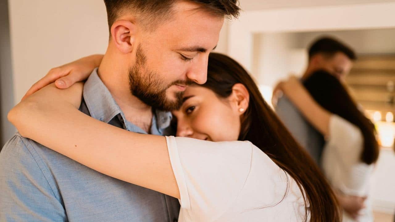 A couple embracing closely indoors
