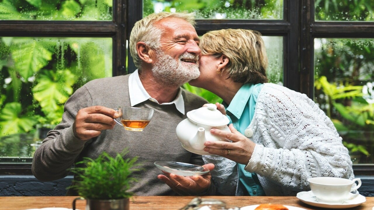 A wife kissing her husband