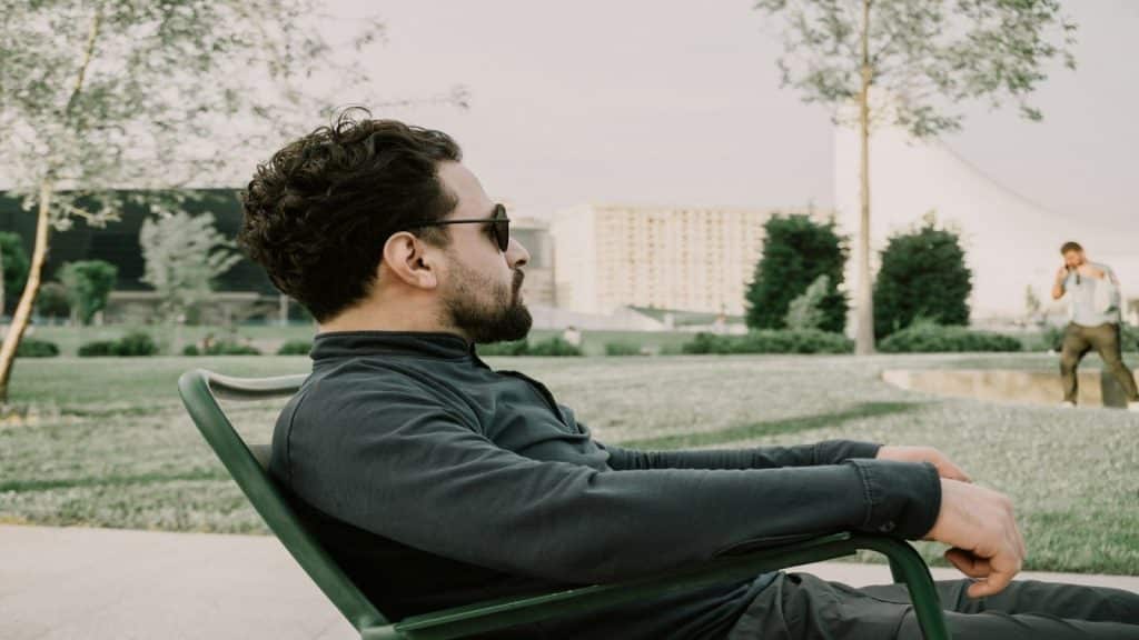 man sitting calmly outdoors