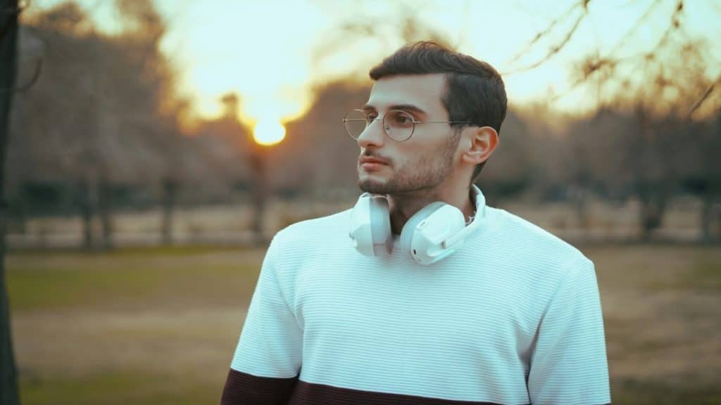 man looking thoughtful outdoors