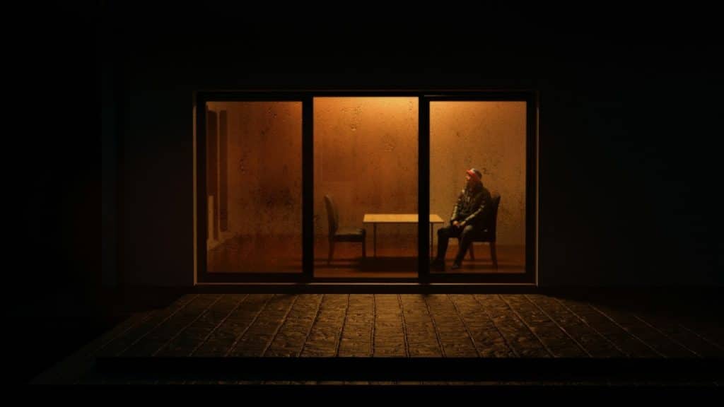 man sitting quietly in dim room