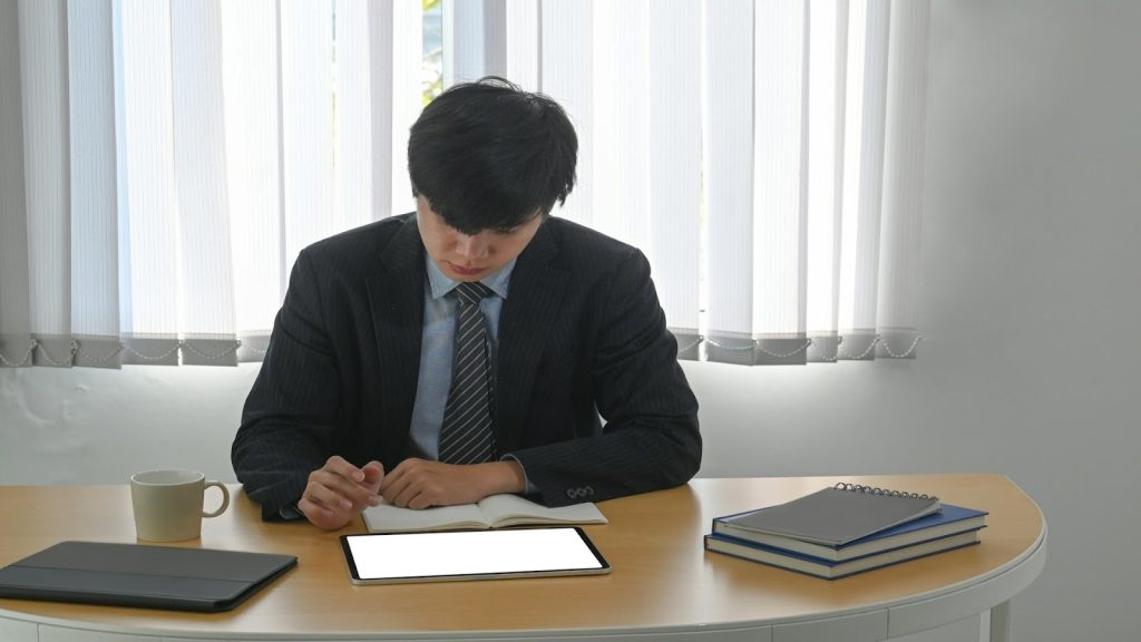 man sitting alone reviewing paperwork