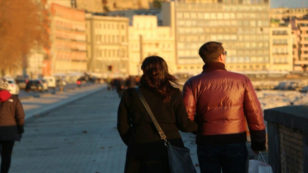 couple walking side by side in city