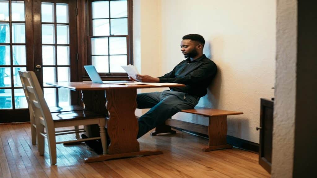 man sitting at desk reviewing finances