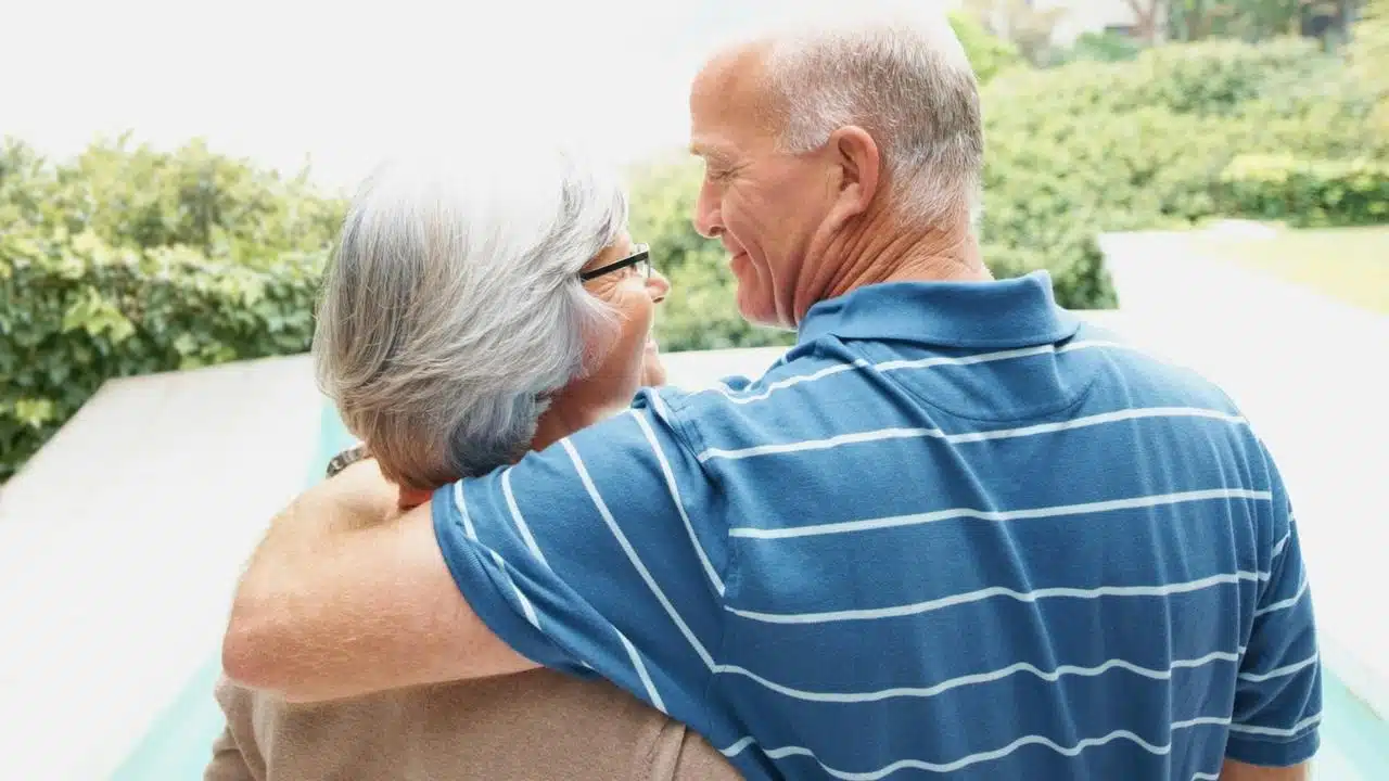 An older couple smiling at each other
