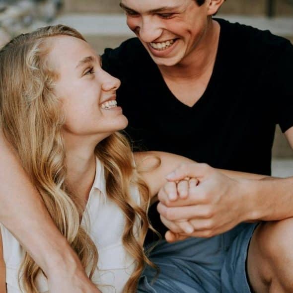 A smiling couple sitting close together