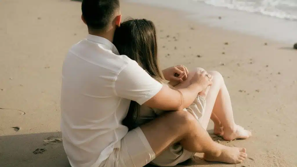 A couple sitting on the beach