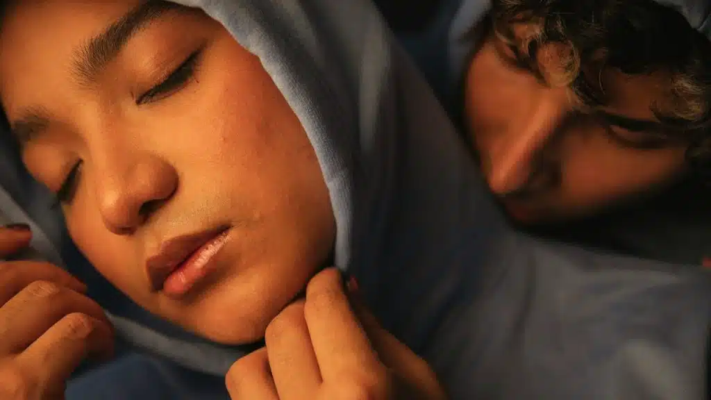 A couple of people who are sleeping together.