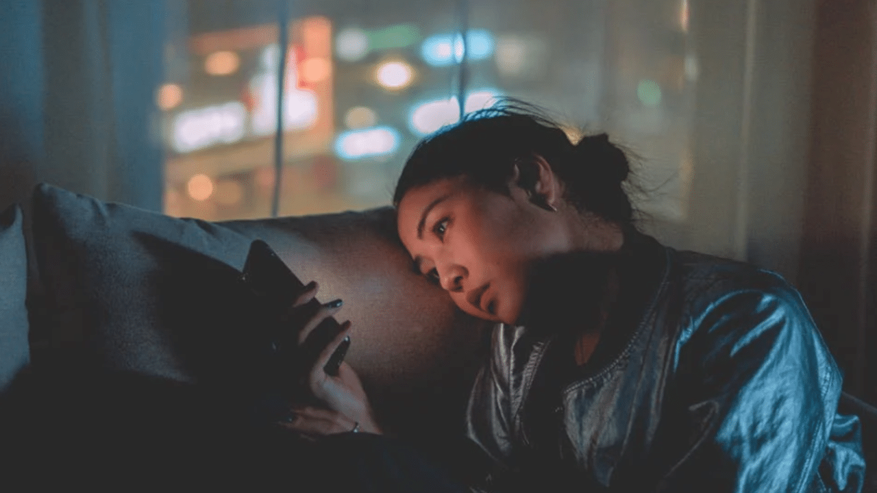 A woman waiting for a text