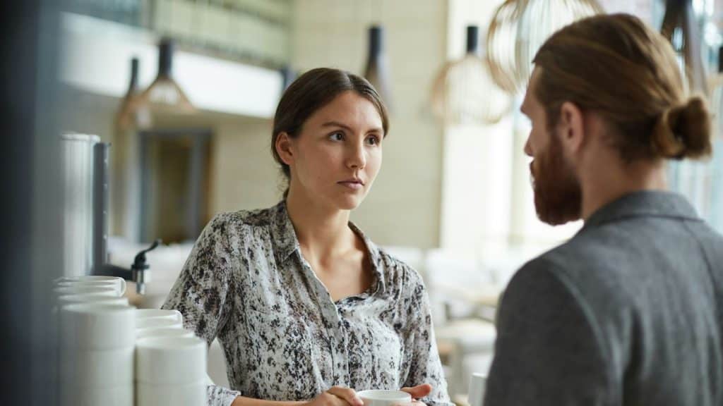 A man and woman looking serious