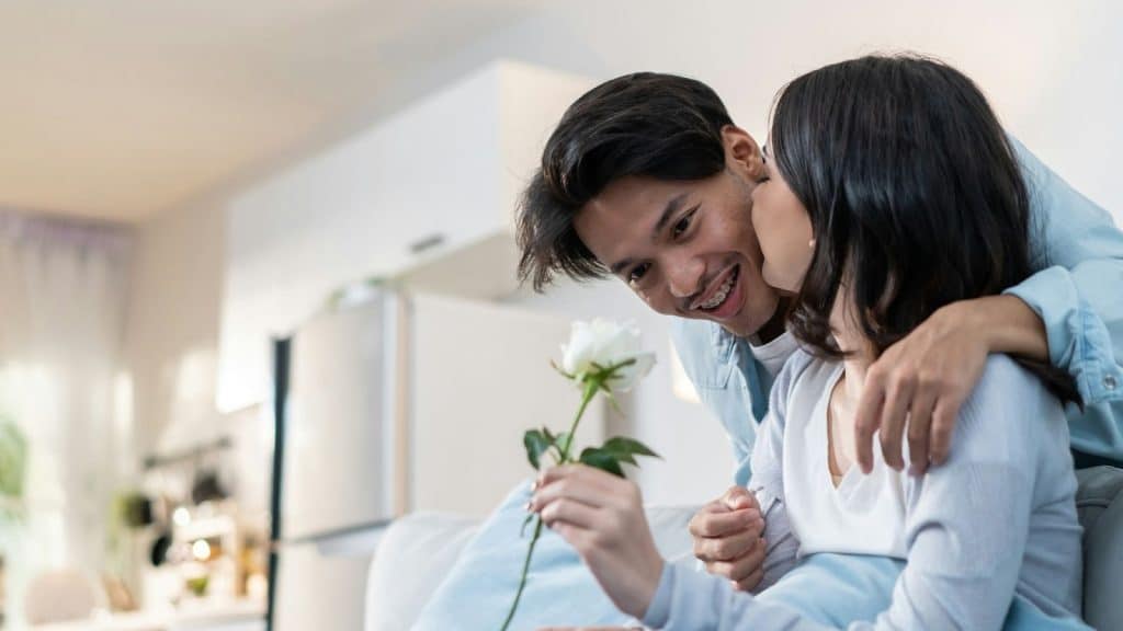 A man giving flower to woman