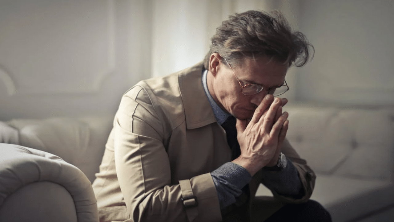 A man looking sad at home