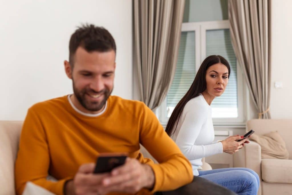 A man texting another woman