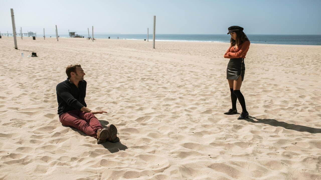 A couple talking on the beach