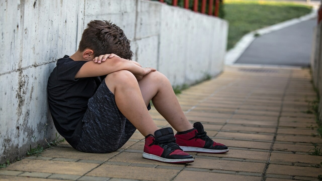 A child isolating and hiding his face