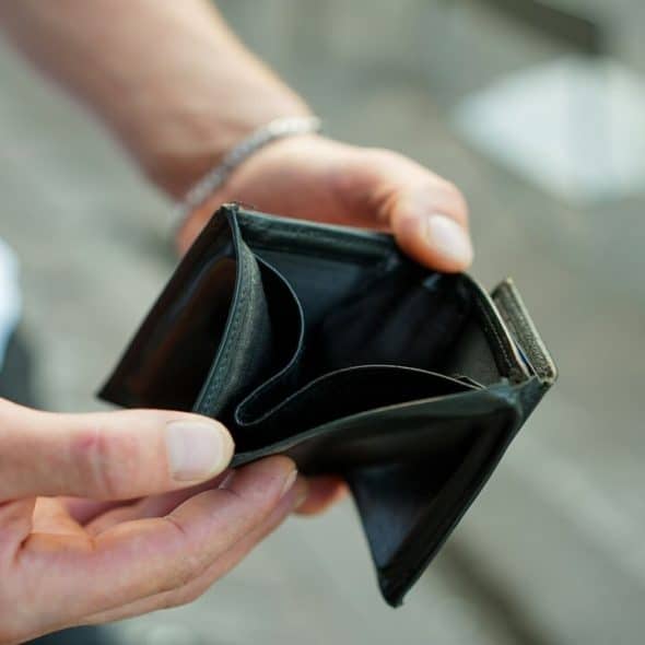 A man holding an empty wallet