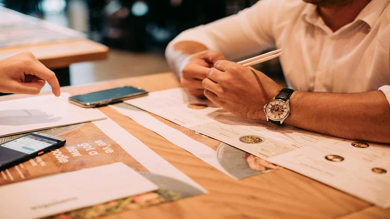 A couple looking at the menu