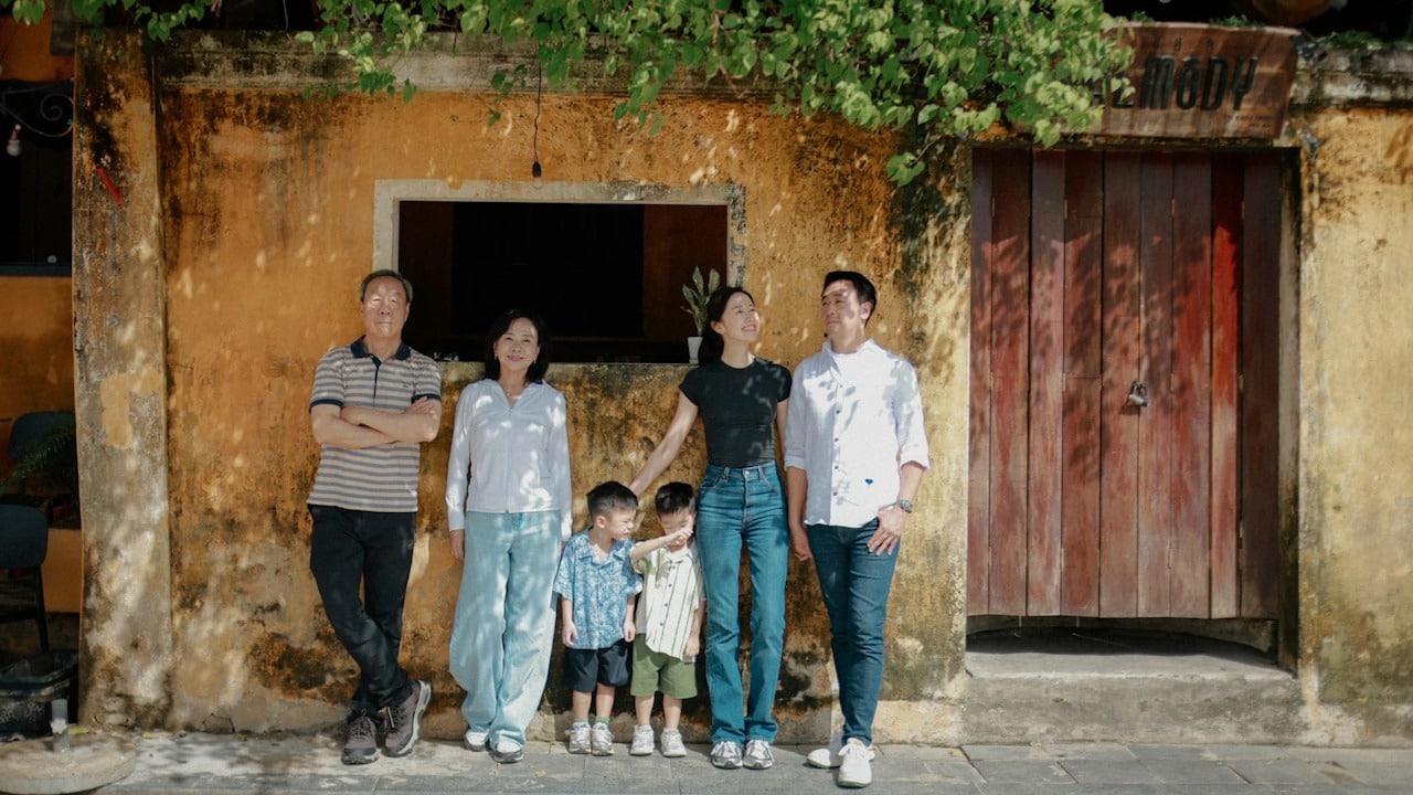 A family standing outside a home.