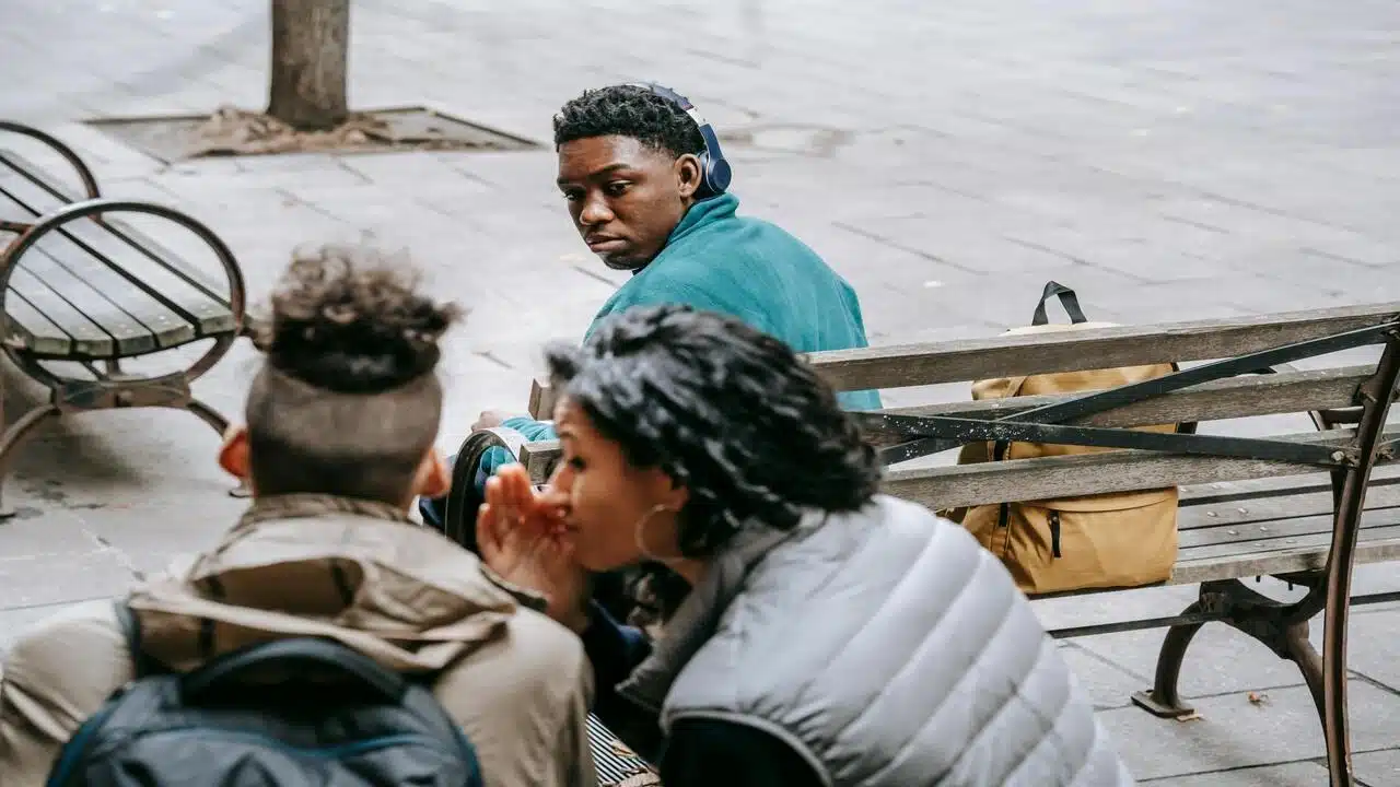 A man looking at his girlfriend gossiping