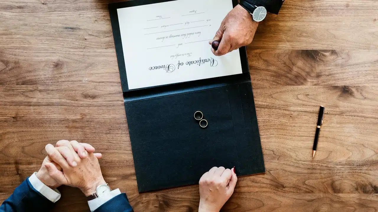 A couple ready to sign a divorce certificate placed before them.