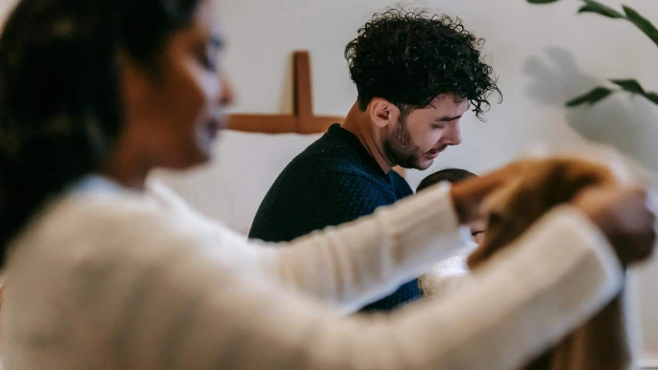 A woman folding laundry with a man