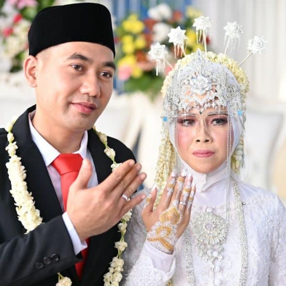 A man and a woman dressed in traditional Thai garb.