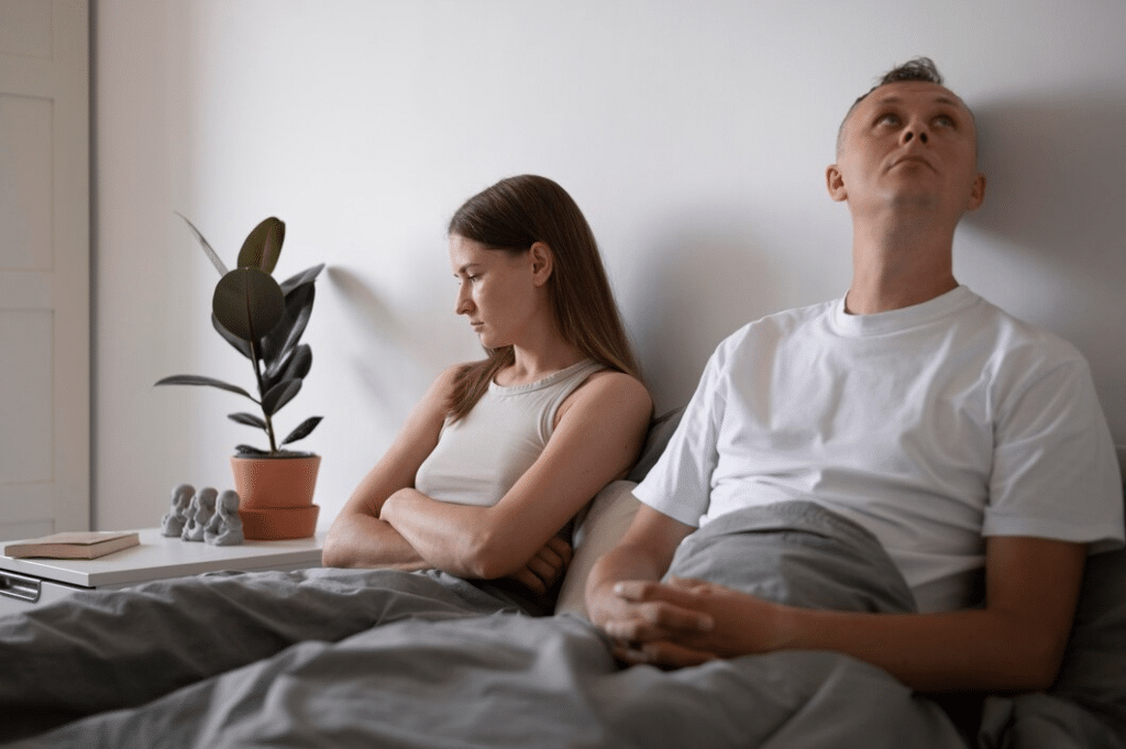 Unhappy couple in bed