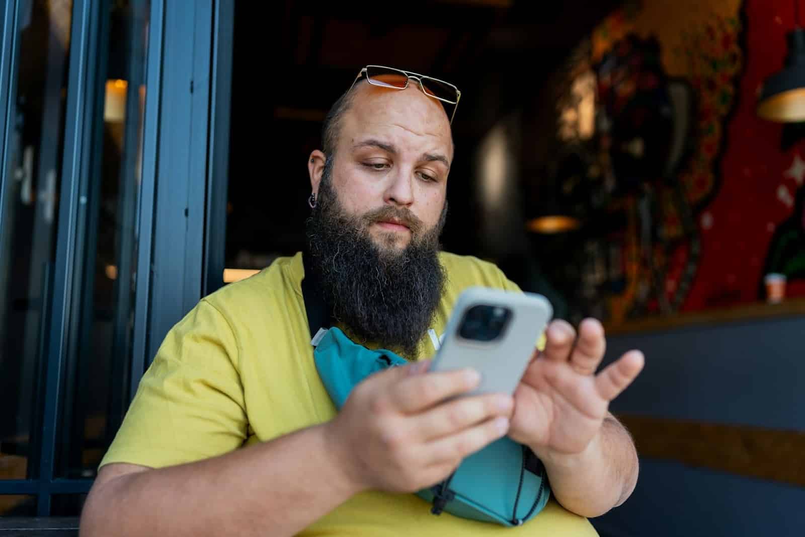 man scrolling phone