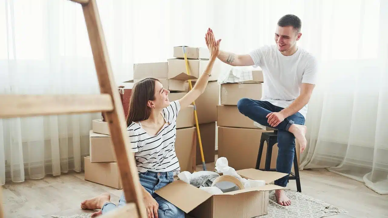 A couple sitting among moving boxes