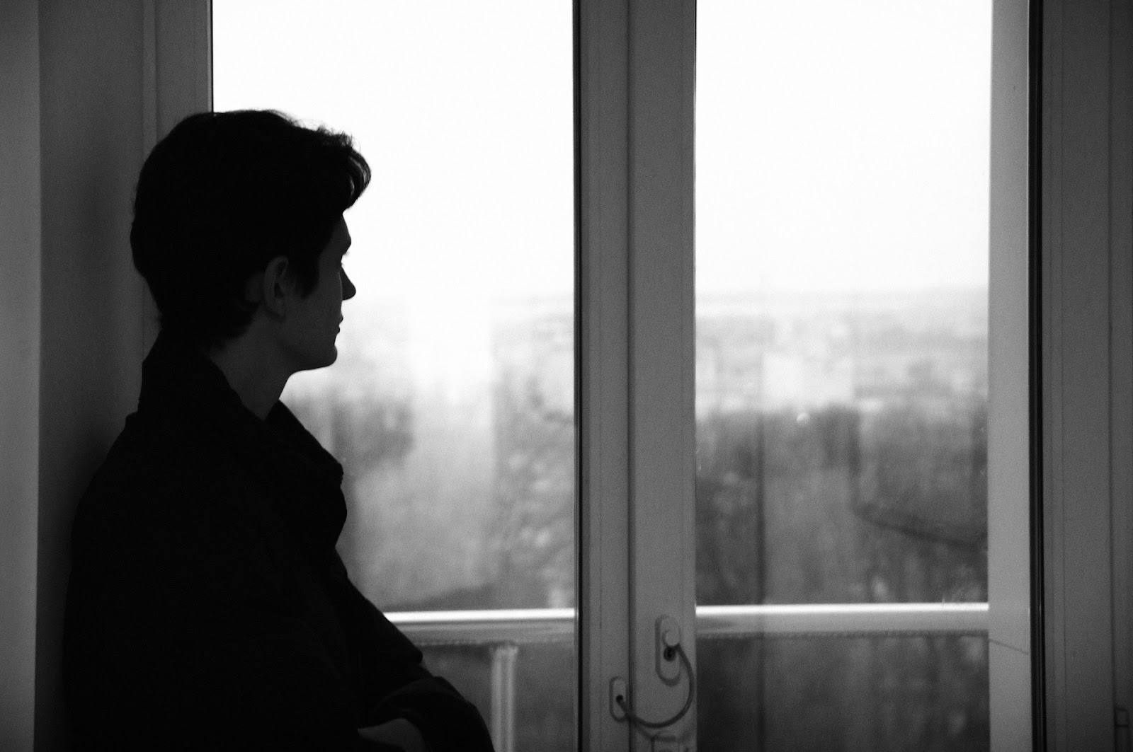 thoughtful man window